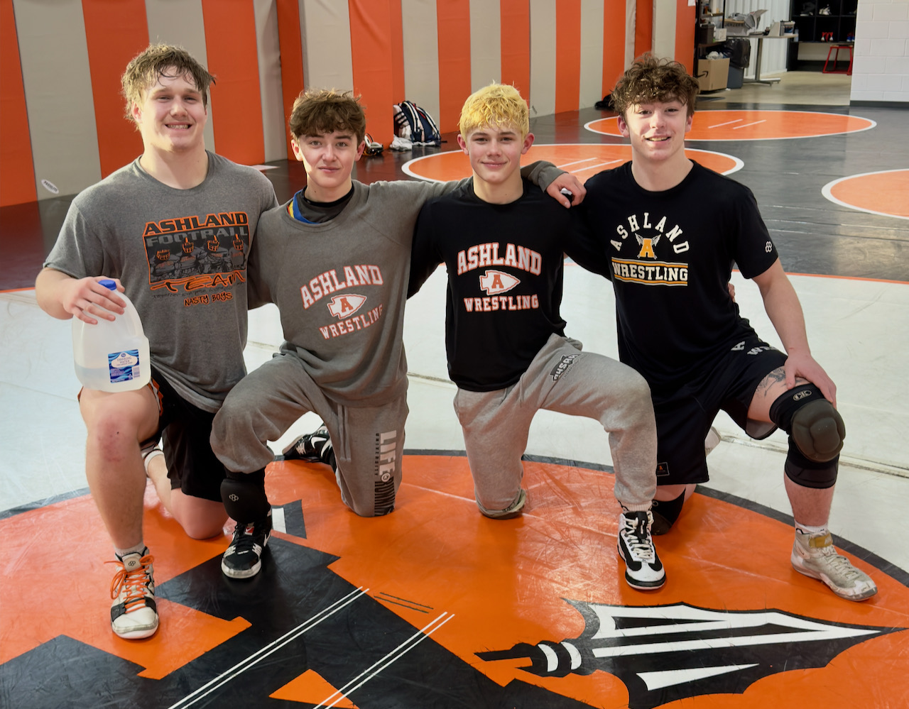 Four state-qualifying wrestlers pose for a photo