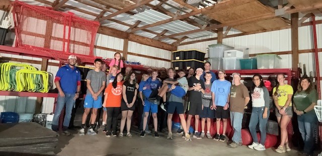 Students stand in a shed