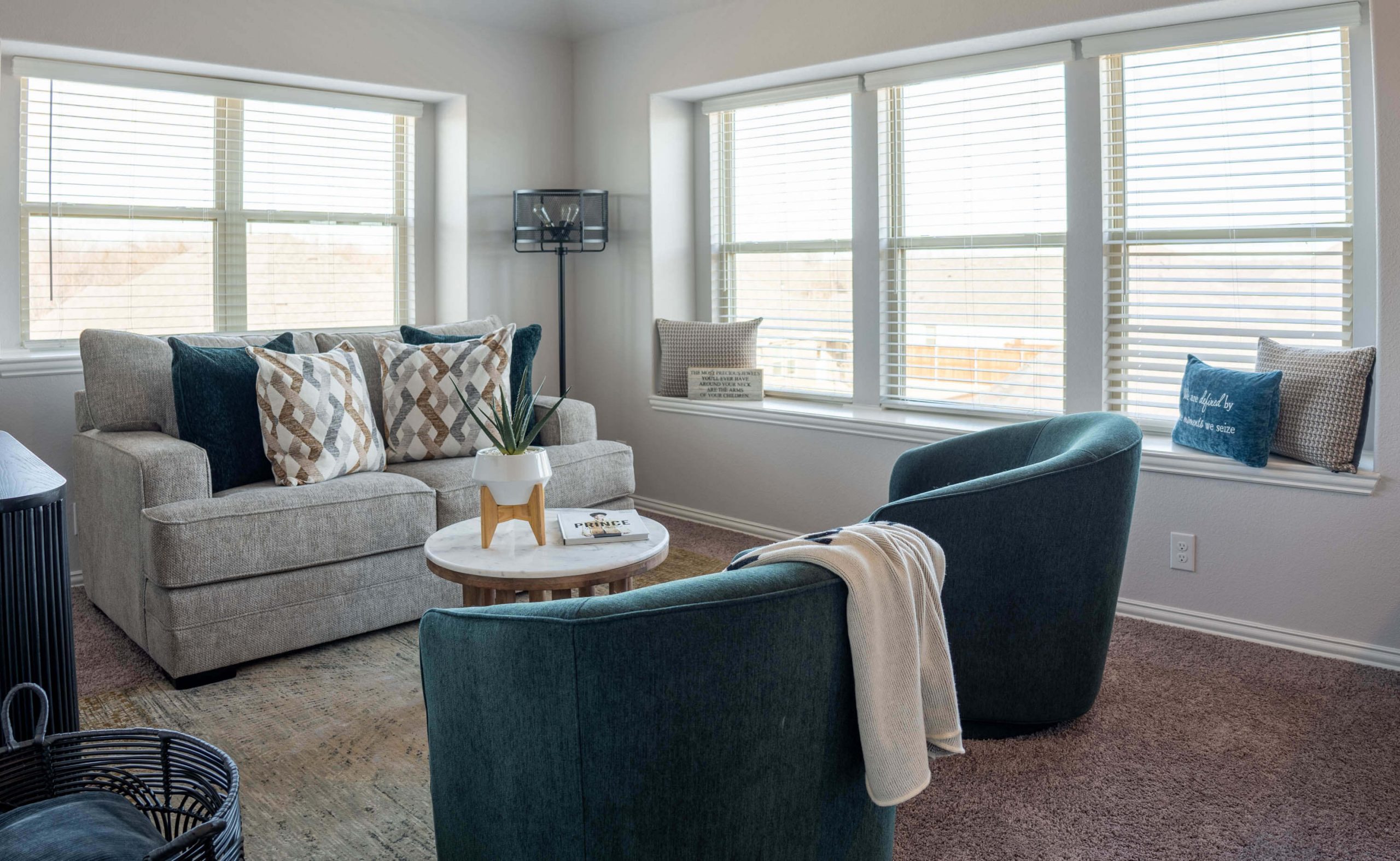 Living room styled with minimalist staging in soft neutral tones.