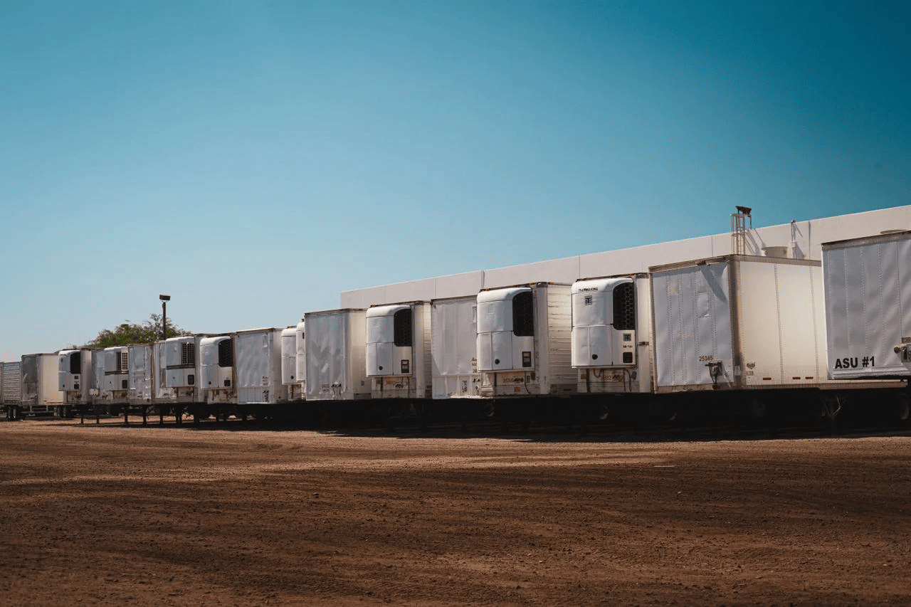 Row of refrigerated trailers parked at a distribution centre