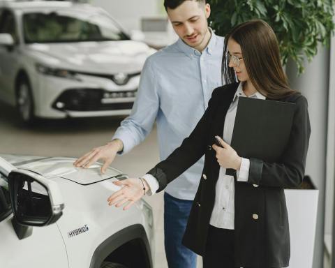 man and woman looking at a vehicle