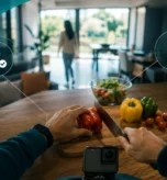 Person wearing a body camera prepares food at home, with privacy and data security icons illustrating responsible AI data collection and management.
