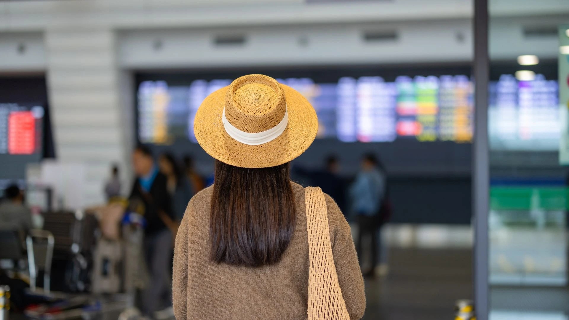 A traveler at Bali airport checking the “All Indonesia” online arrival card requirements.