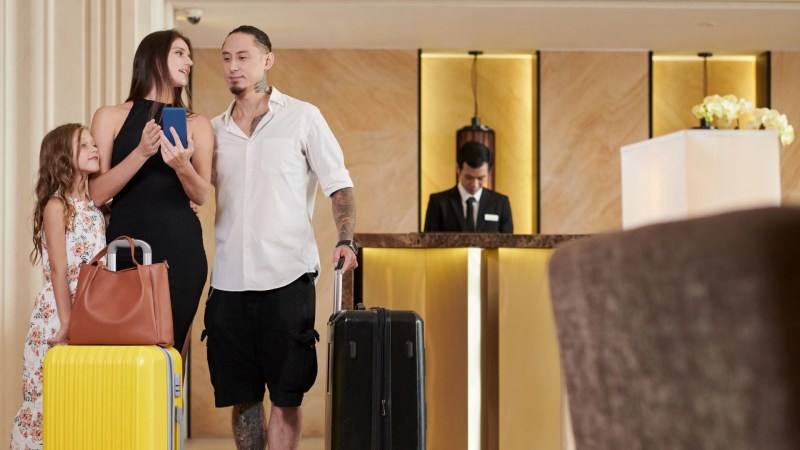 Family traveler checking into a hotel in Bali after making a last-minute booking.