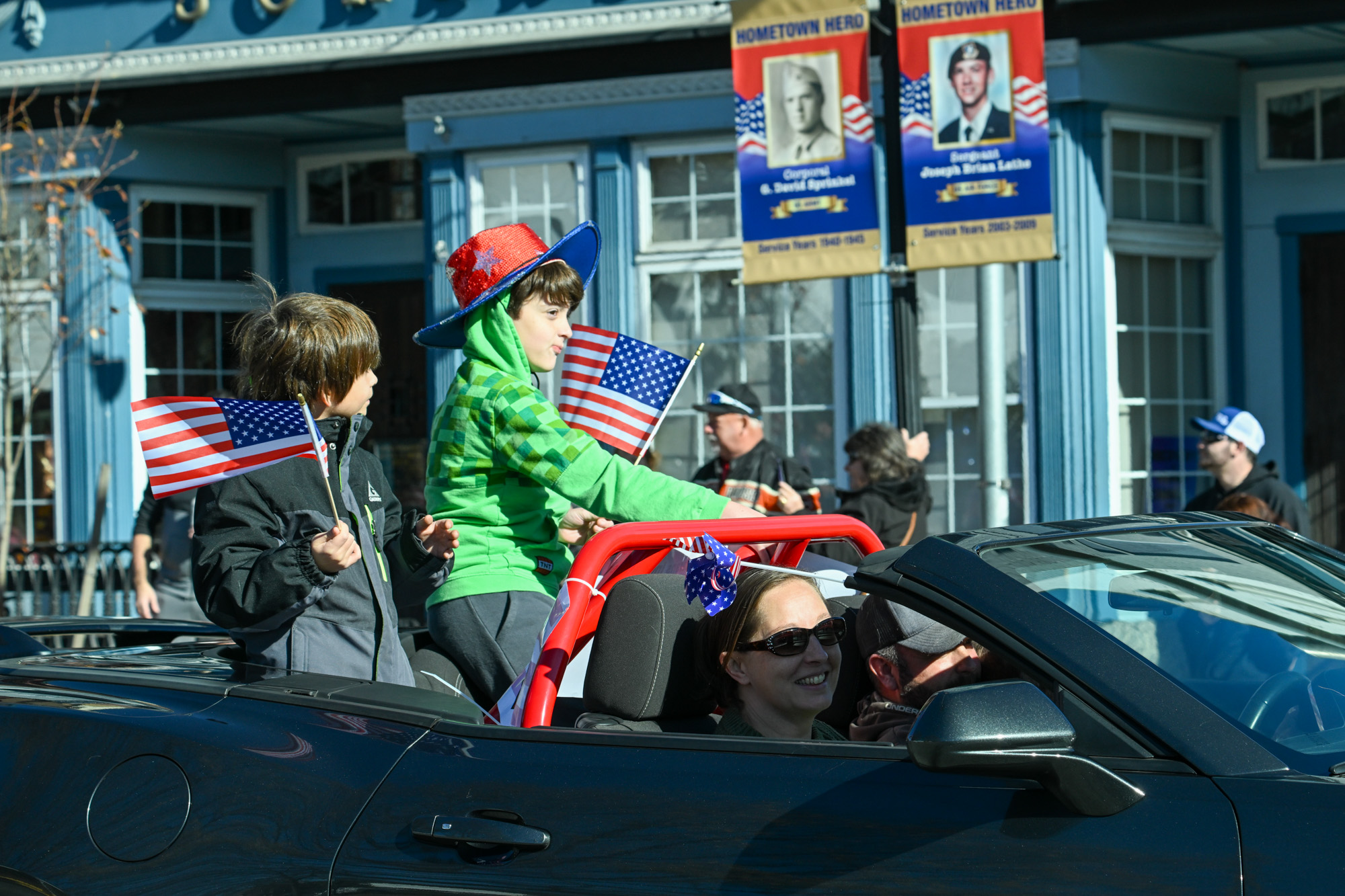 Mike Franz drives with Julia Lis, Ben Franz, 7, and Shawn Franz, 12, along Main Street during the first annual Veterans Day Parade in Westminster.(Karen Jackson/Freelance)