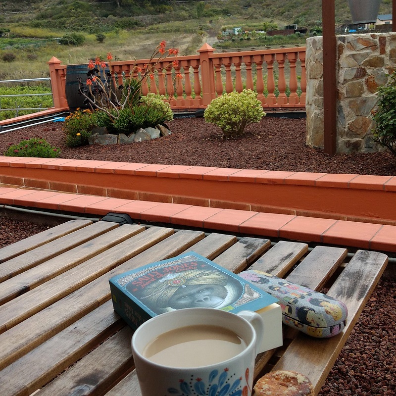 Buch, Kaffe, Brille auf einem Tisch