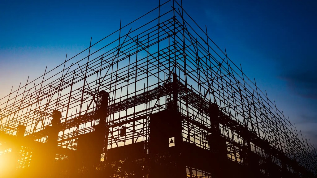 Steel scaffolding and framework silhouetted against the sunset sky, showing modern construction in multi-residential building development