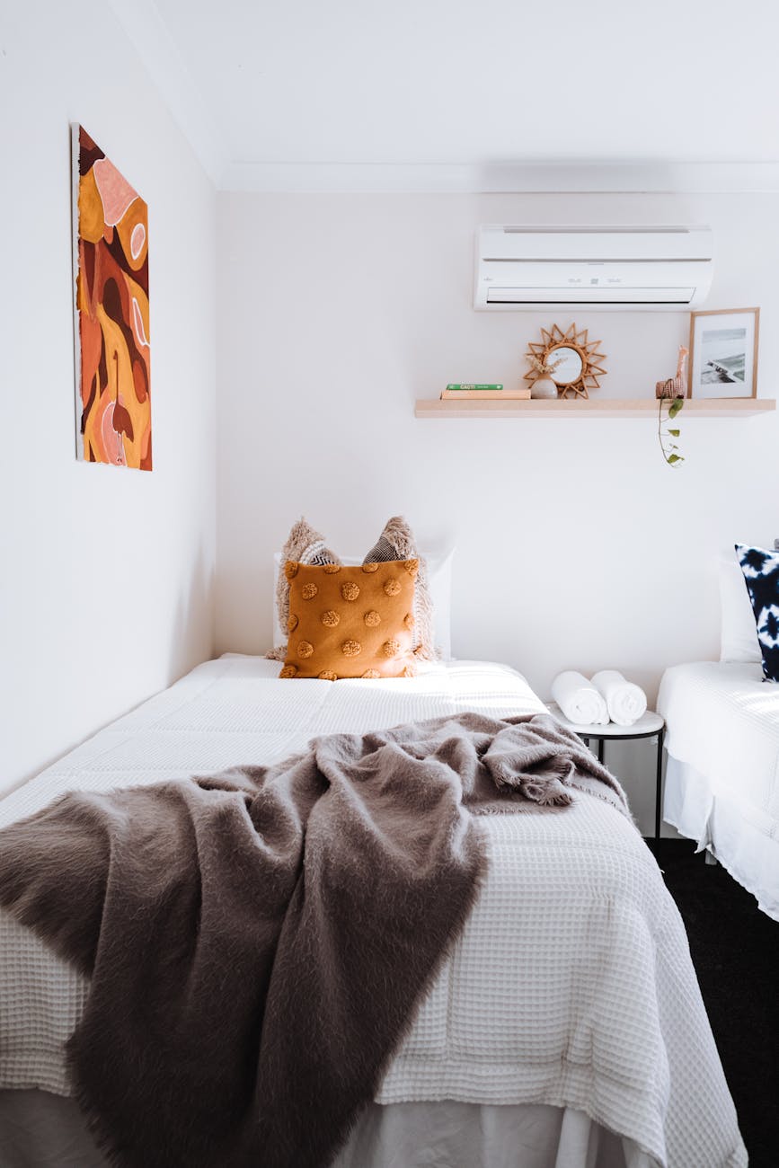 light bedroom with cushions on bed