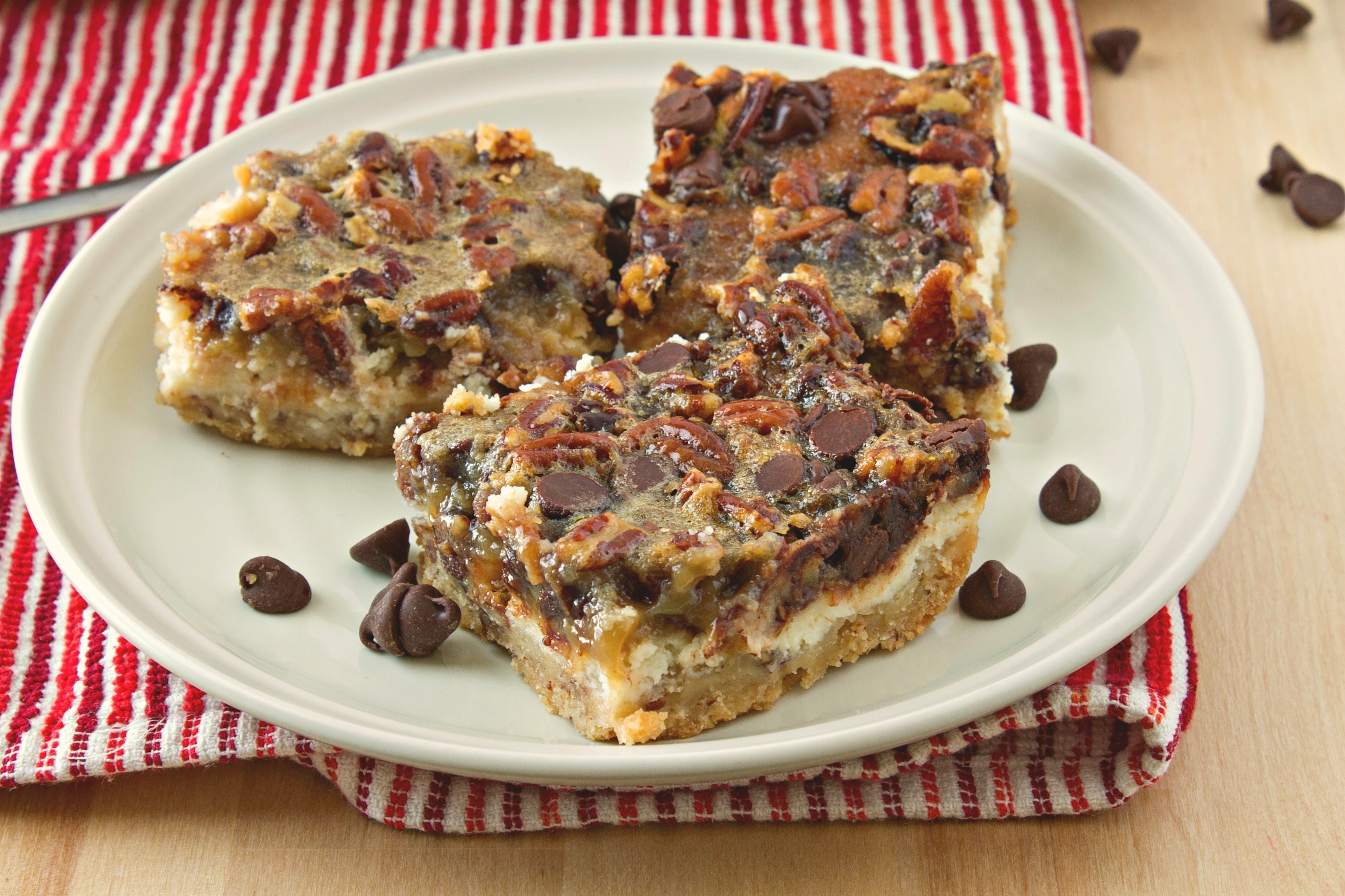 styled shot of chocolate pecan pie cheesecake bars