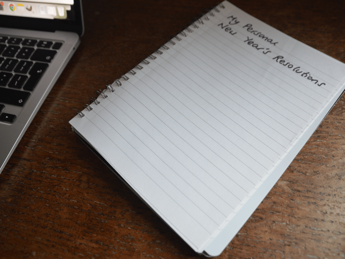 A blank notepad with writing at the top of the page which reads 'my personal new year's resolutions'
