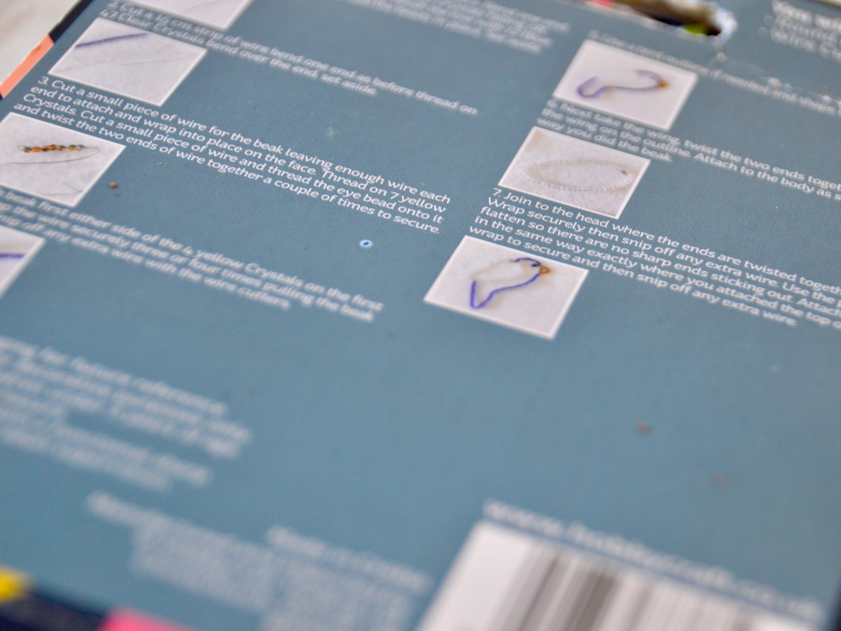 Close up of instructions on the back of a wire beading kit. The text is very small.