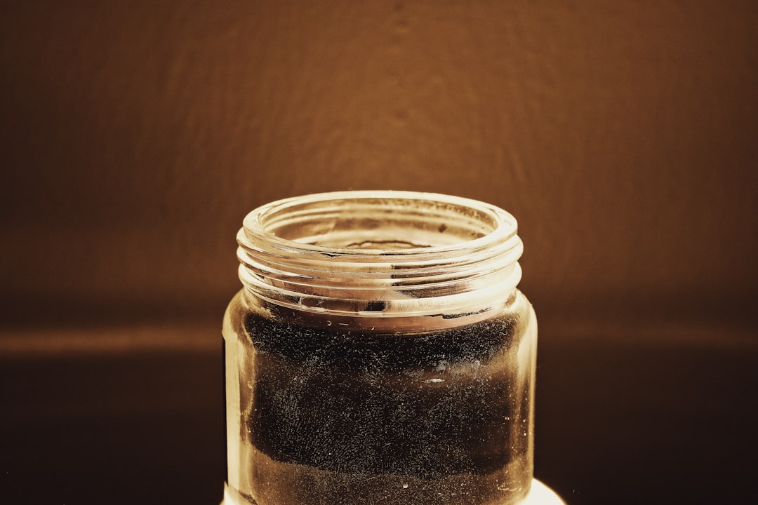 clear glass jar with brown powder