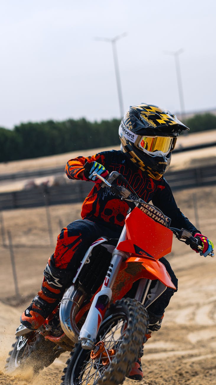 young motocross rider on dirt track
