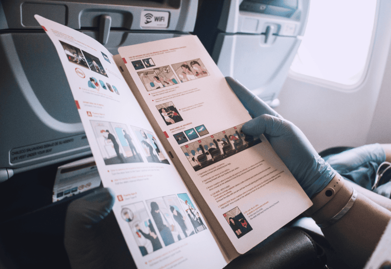 Passenger reading safety instructions onboard
