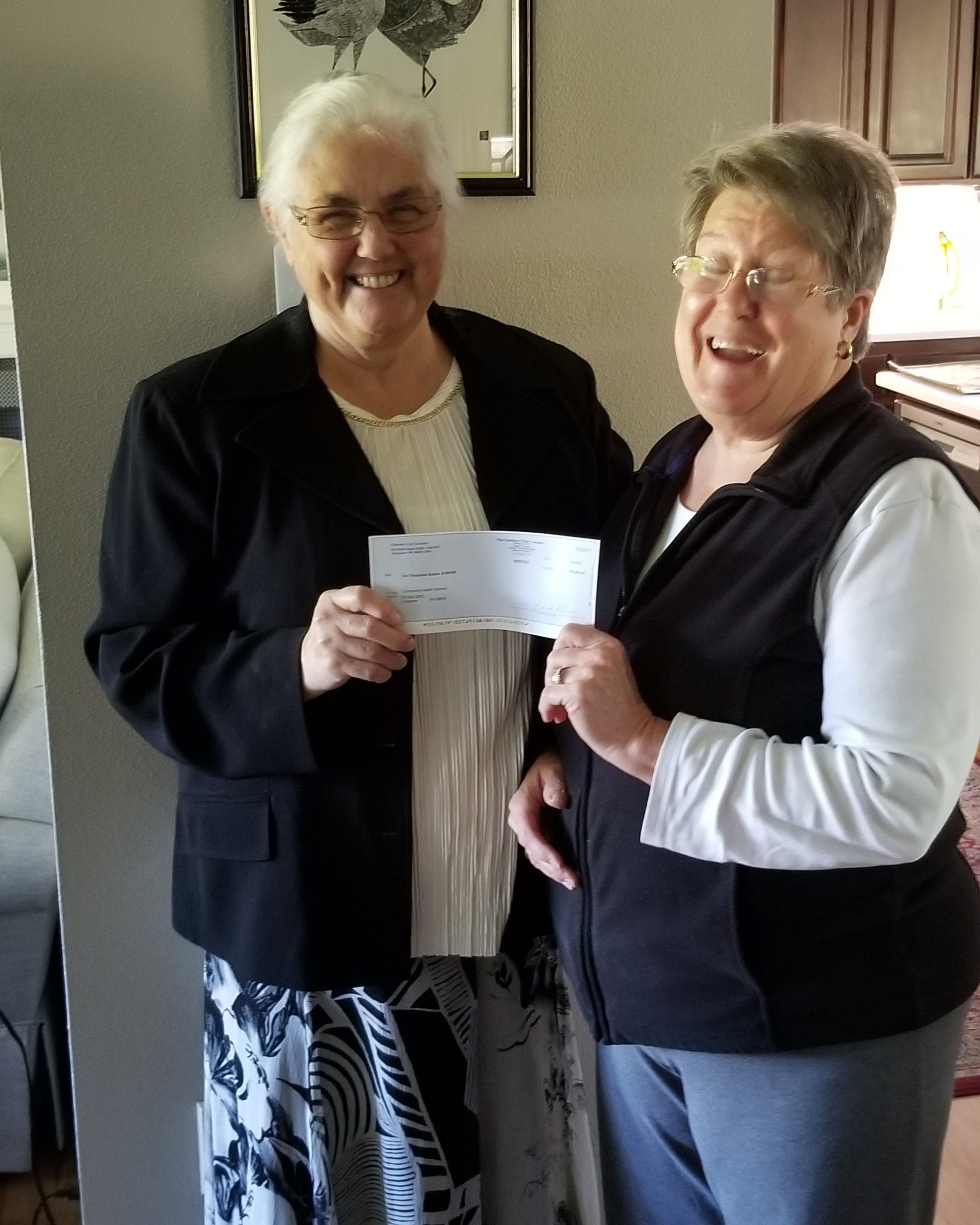 Kay Dalke-Sheade, Executive Director of the Price Foundation presenting a check for $10,000