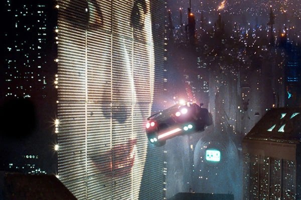 Futuristic flying car navigating through a neon-lit, high-rise cityscape at night