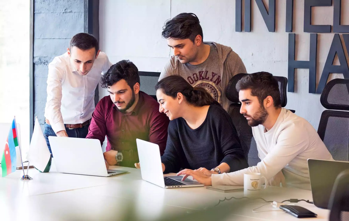 a team working on a their laptops in an office 