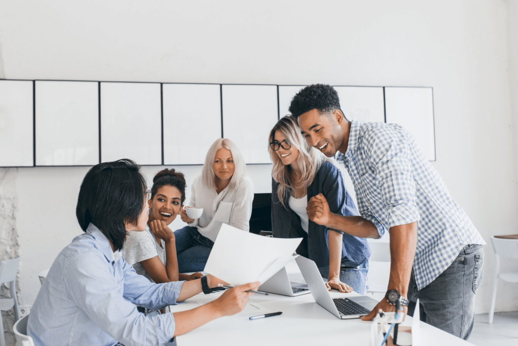 A team of 5 working together on a project together.