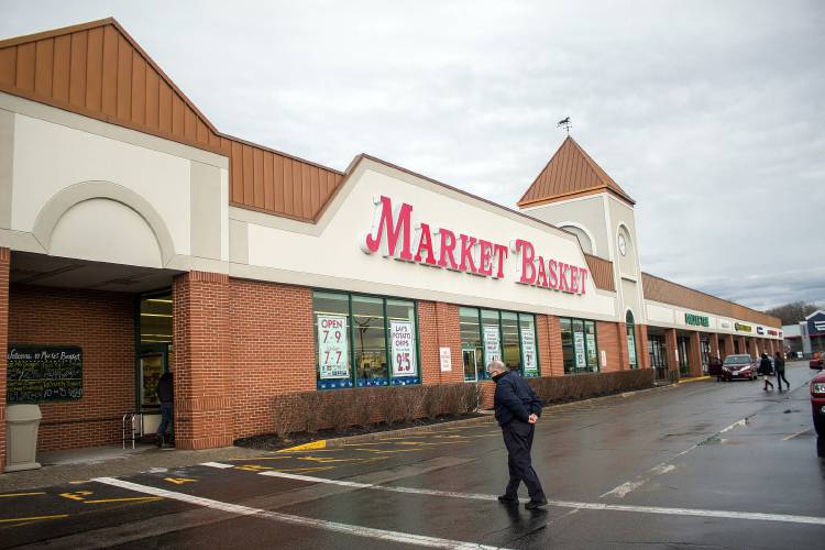 Image 1: A customer walks into Market Basket at Fort Eddy Road in Concord.