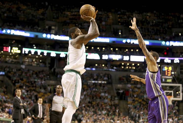 Boston Celtics' Kyrie Irving (11) shoots over Sacramento Kings' George Hill (3) during the first half of an NBA basketball game in Boston, Wednesday, Nov. 1, 2017. (AP Photo/Mary Schwalm)