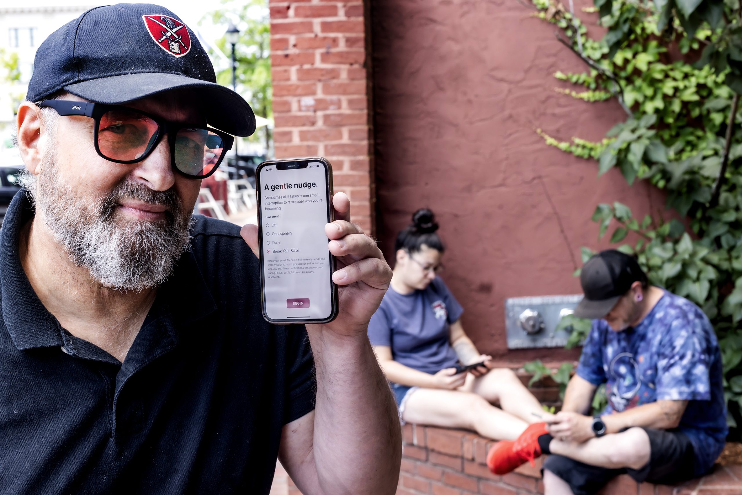 Eric Wolfram holds his phone with his app called MeBeMe, as in “helping me be myself.” Wolfram says MeBeMe breaks up endless scrolling or other mindless activities. GEOFF FORESTER / For the Monitor