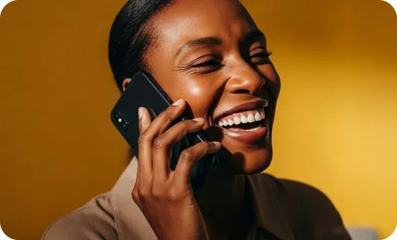 Woman laughing while talking on phone