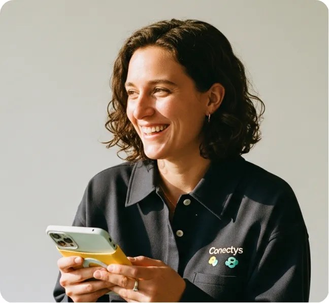Smiling person holding a phone