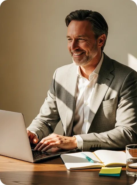 Middle aged man typing on a laptop