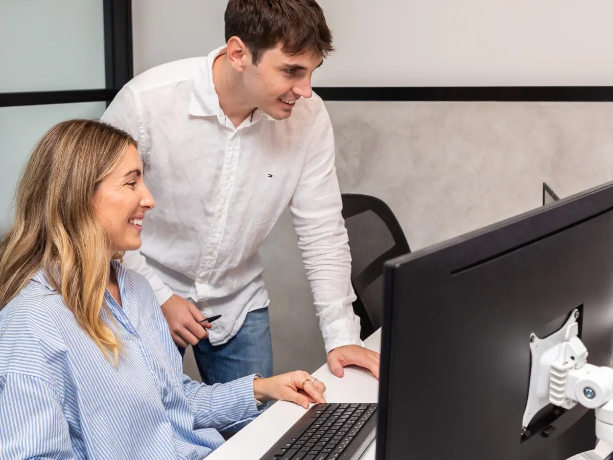 Connected Media Group team members collaborating at a computer