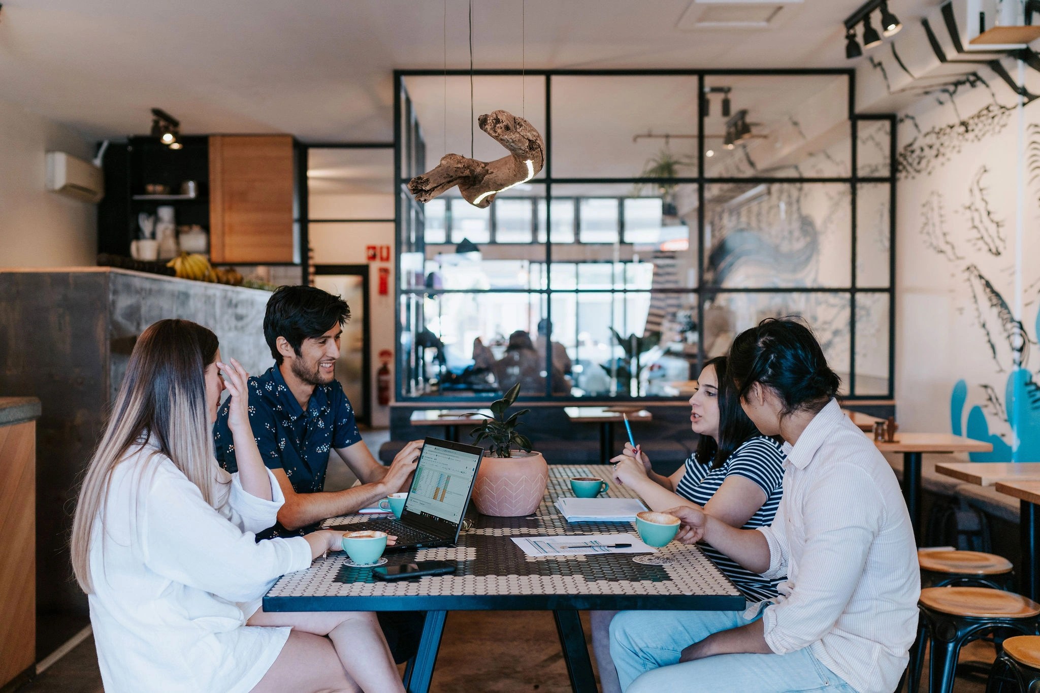 Connected Media Group team members collaborating in a café