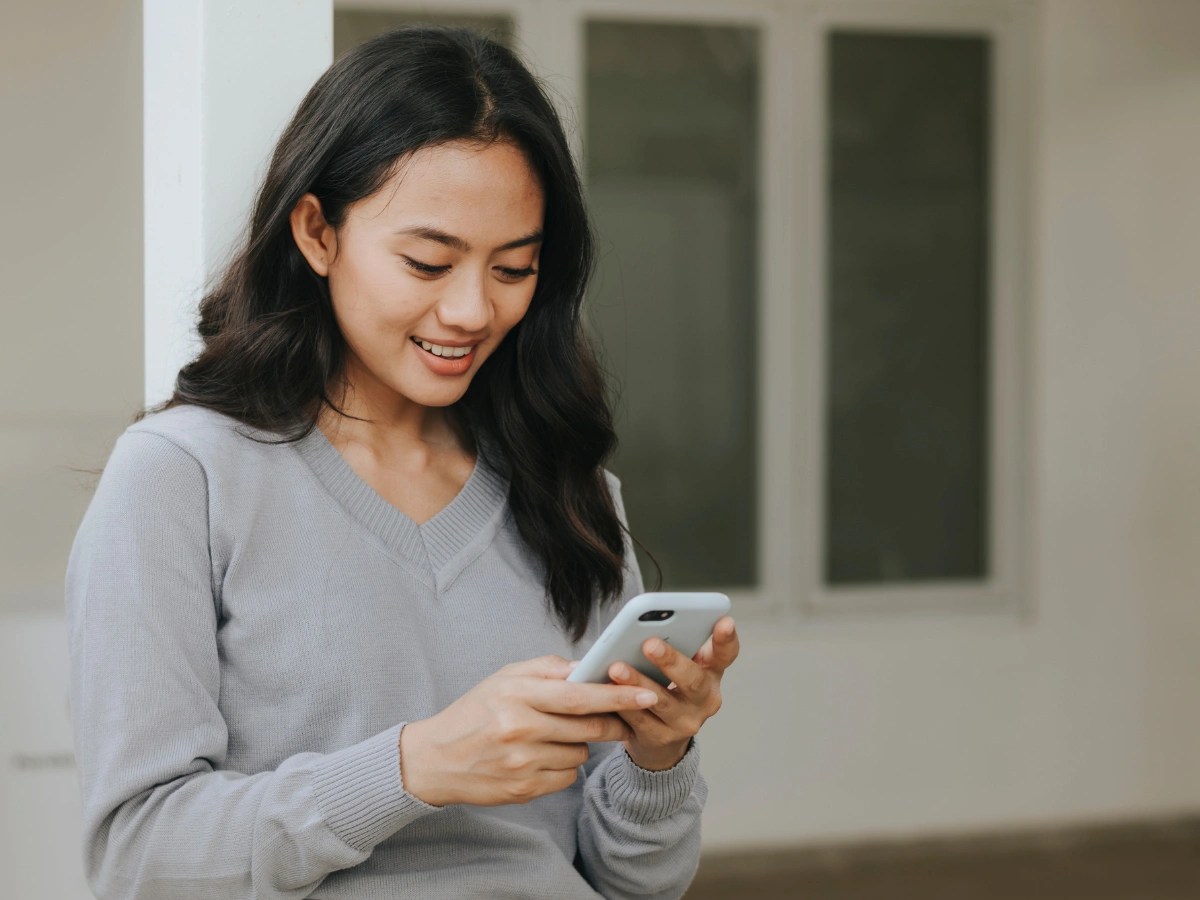 Woman viewing video advertising content on a smartphone