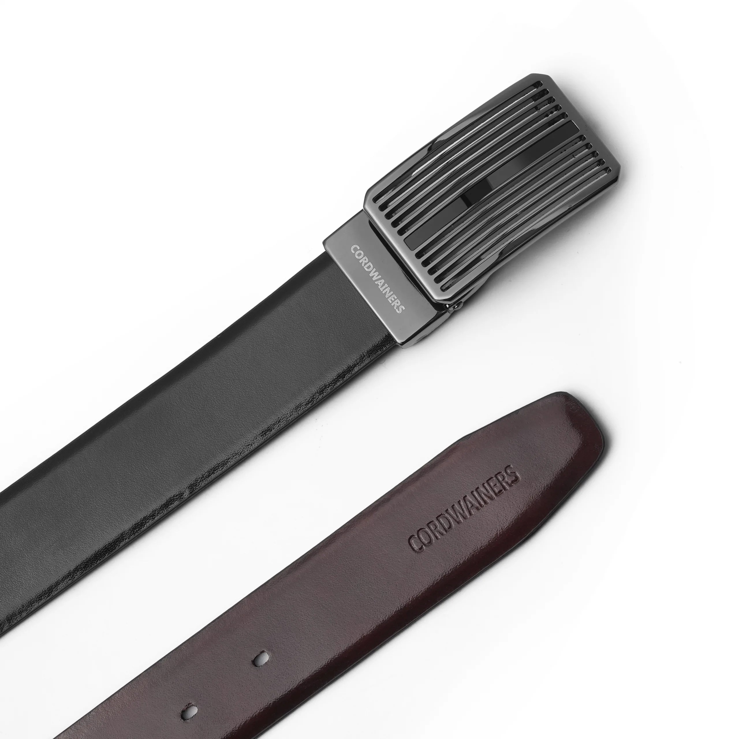 Premium reversible leather belt with a sleek silver buckle. Dual-sided in black and charry for versatile, elegant styling.