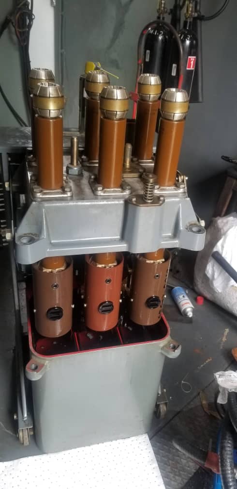 Close-up of a high-voltage industrial circuit breaker used in electrical power systems.