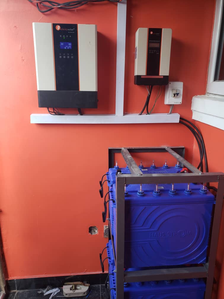 Solar inverter for your home installed with charge controller and battery bank in an indoor power setup.