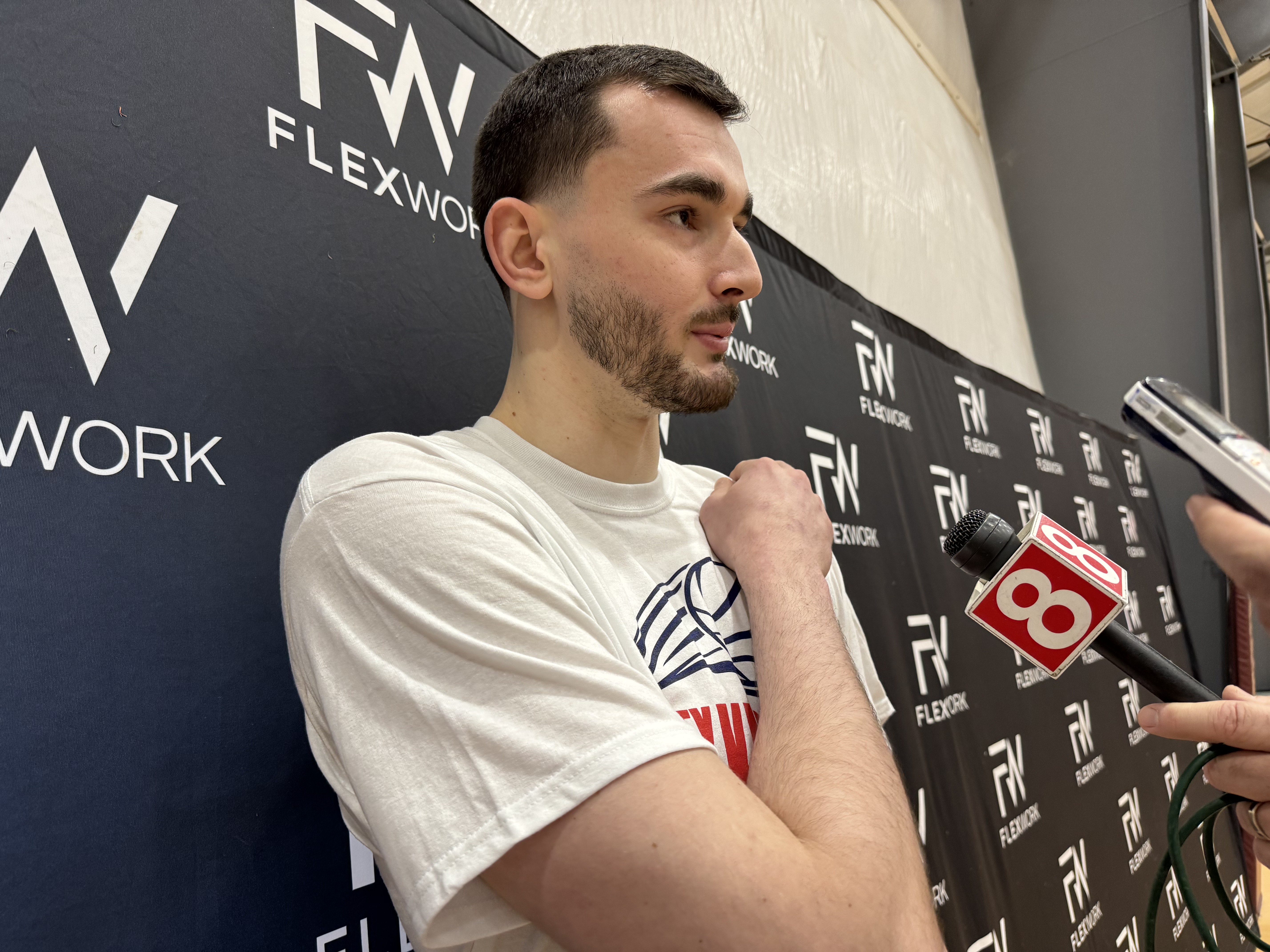 UConn's Alex Karaban speaks to the media during Saturday's basketball camp in Newtown attended by nearly 200. (Joe Arruda/Hartford Courant)