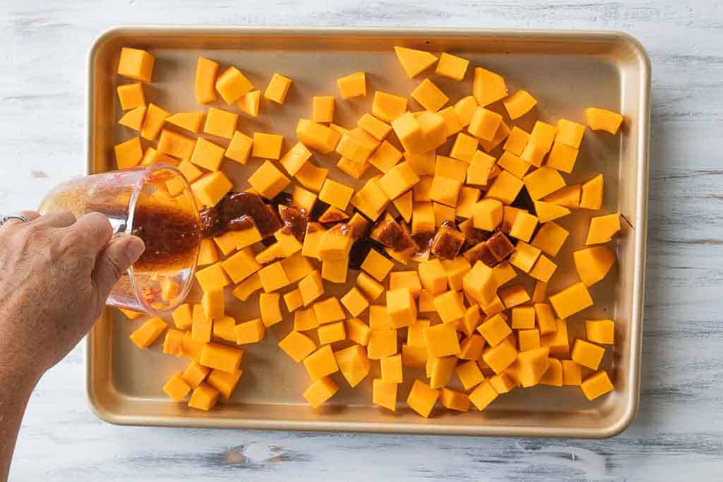 melted butter and brown sugar mix poured on top of butternut squash chunks