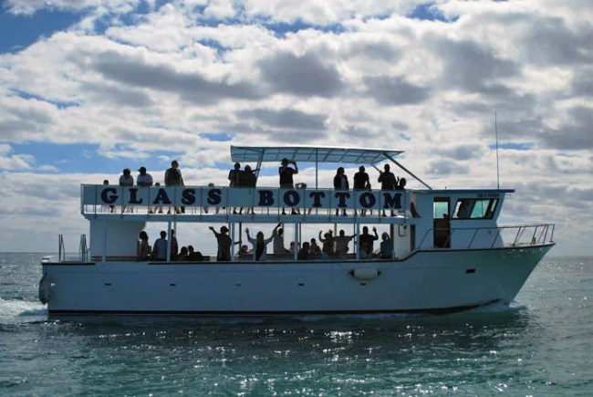 people waving aboard a glass bottom boat in freeport