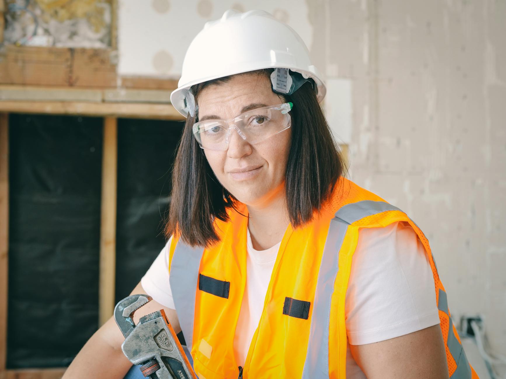 handywoman holding a plumbers wrench