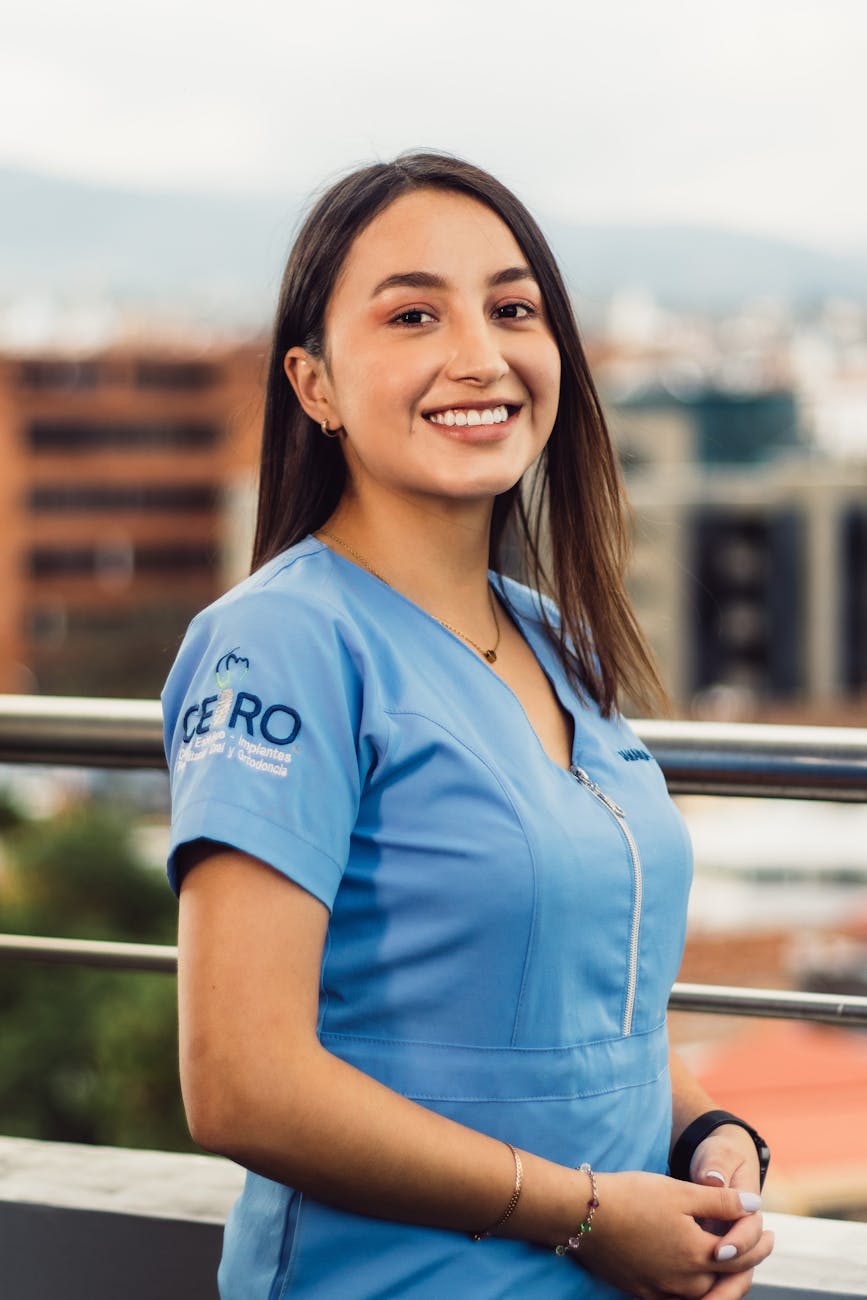 smiling female nurse outdoors in urban setting
