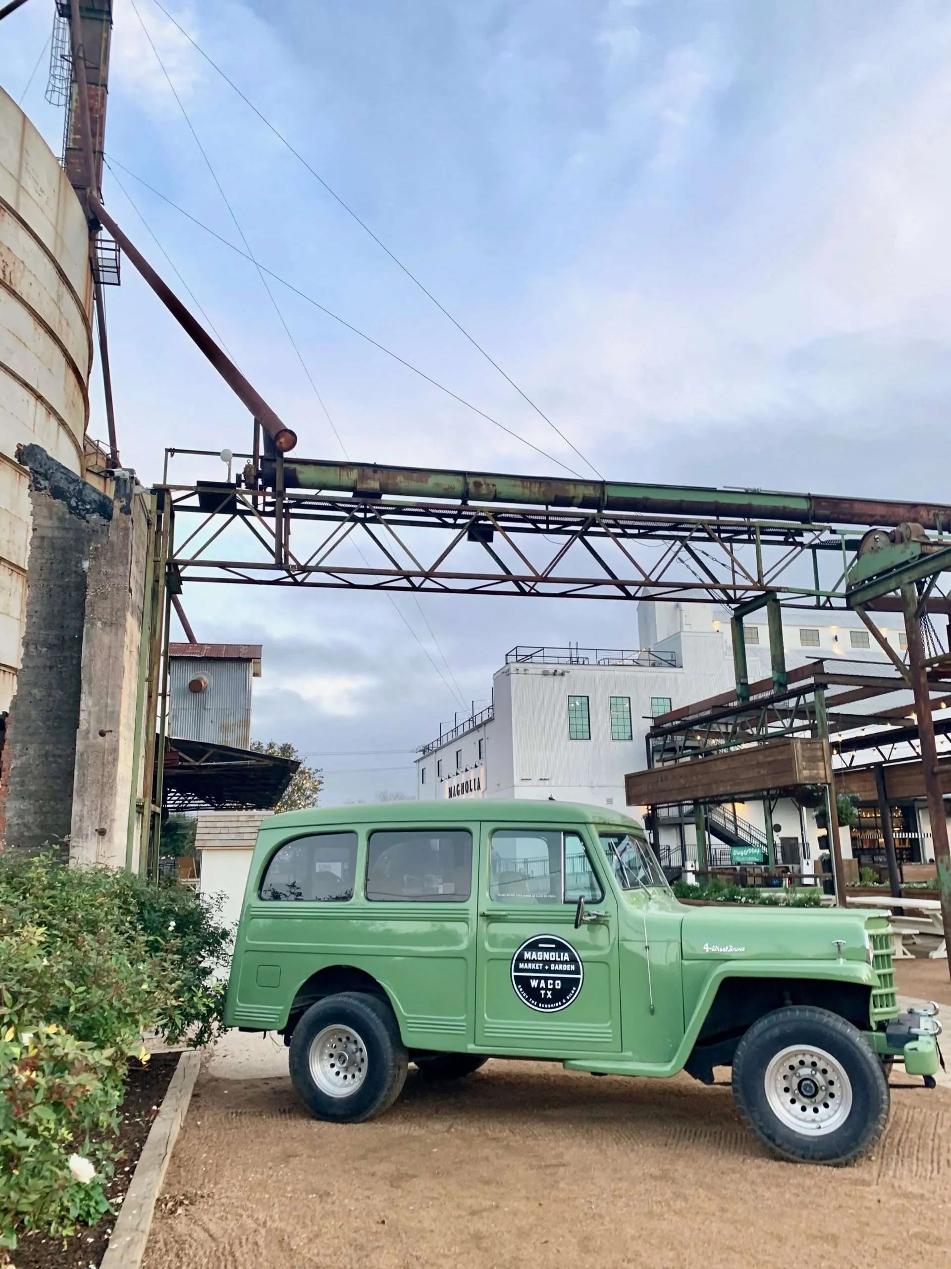 The green truck sits right outside the garden area.