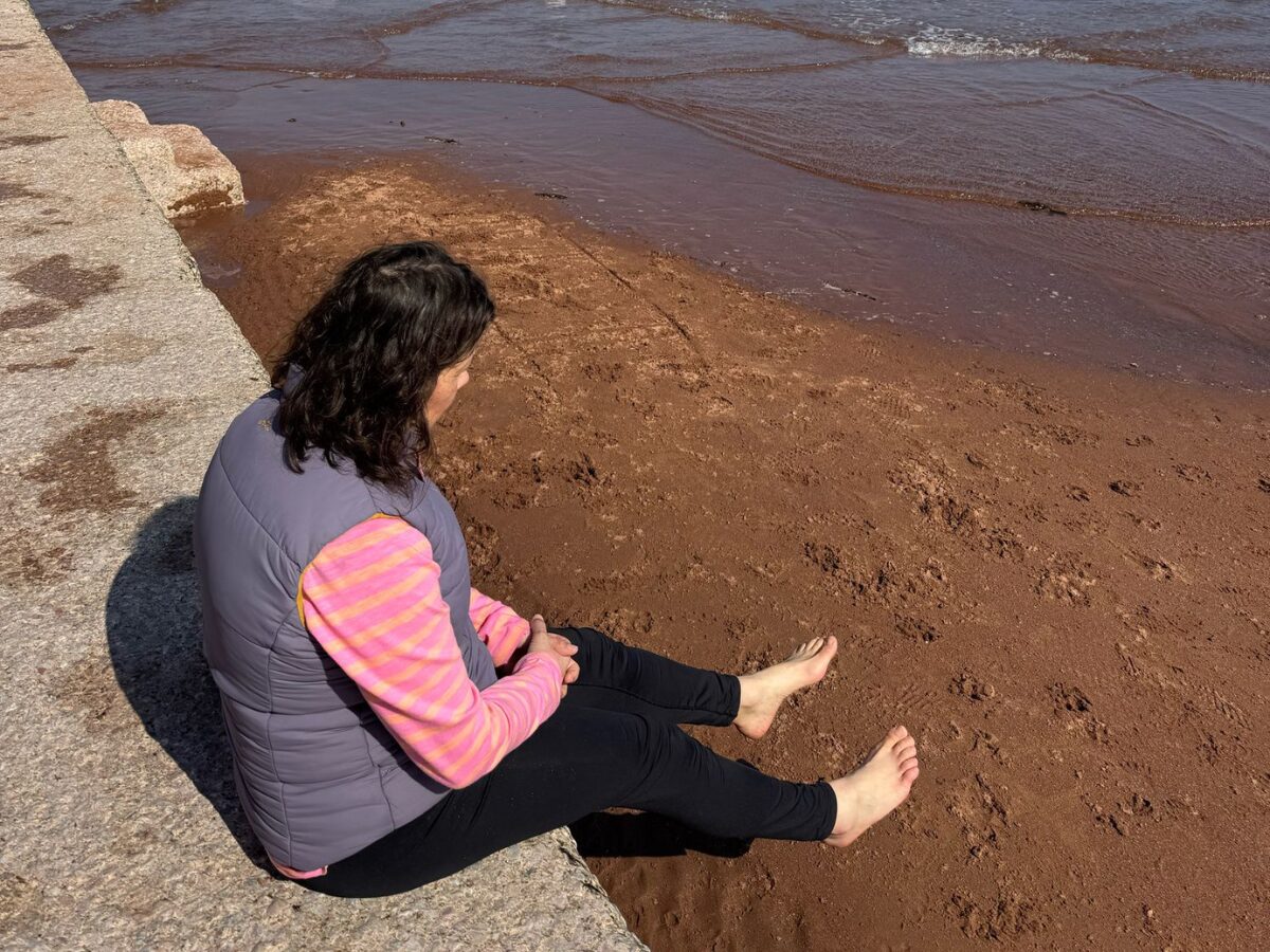 woman sitting on beach