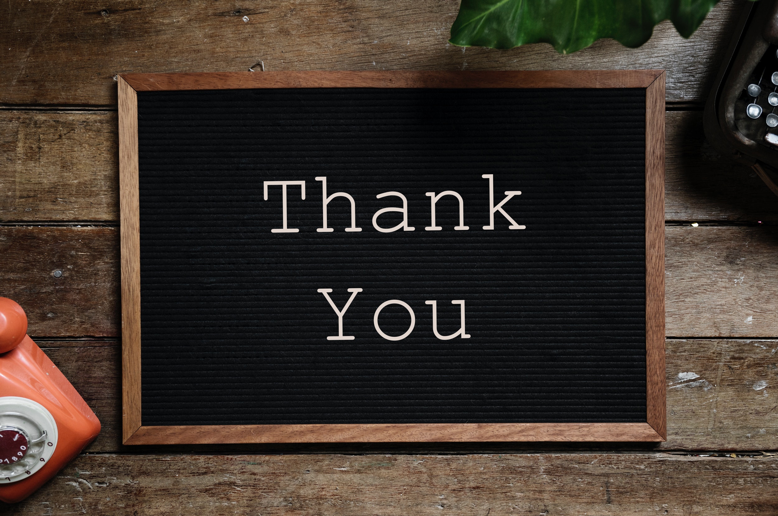 A black noticeboard with the words "Thank You" written in white