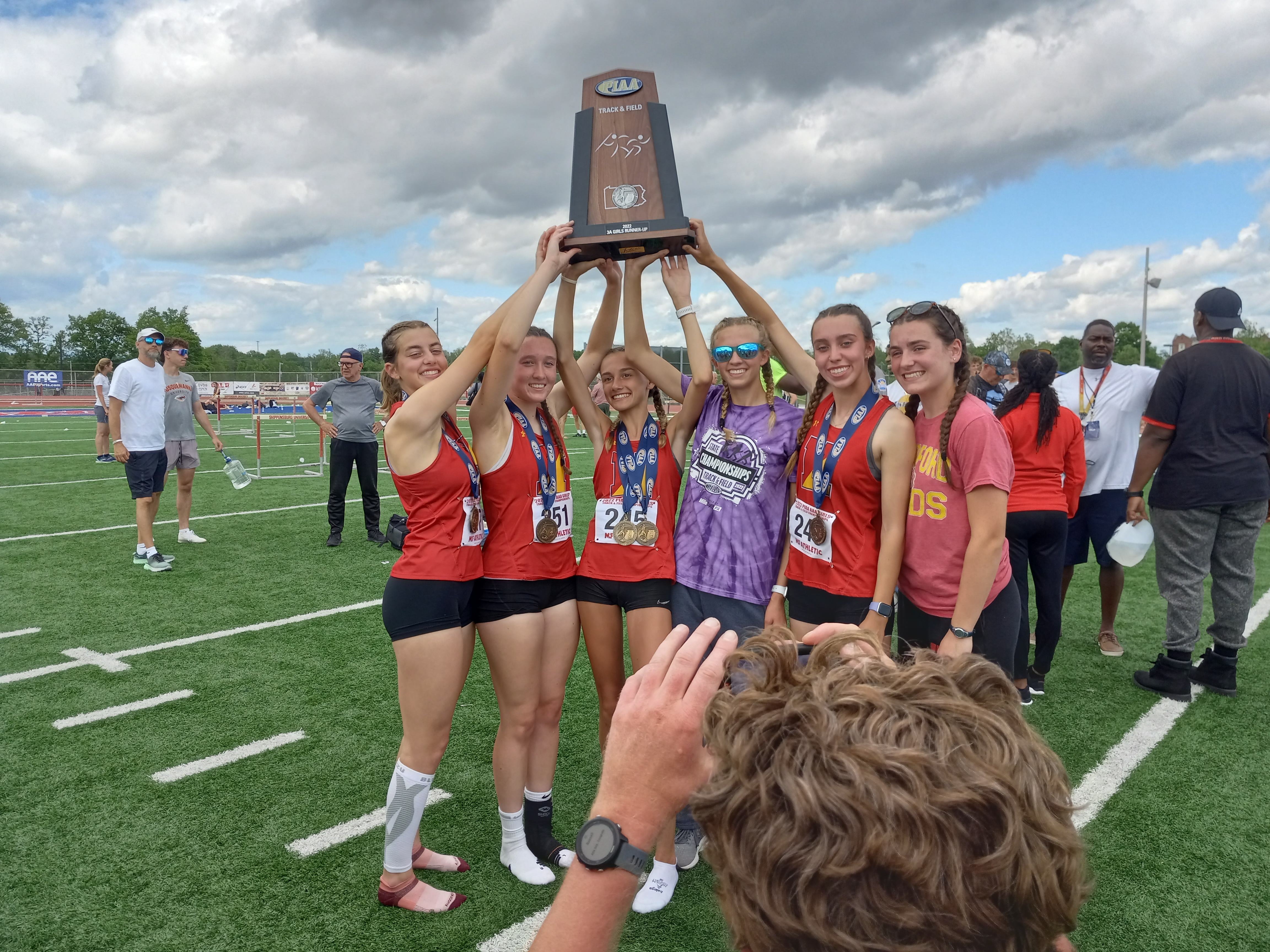 Members of the Haverford girls track team hold up the second-place trophy at the PIAA Track & Field Championships on Saturday. (MediaNews Group photo).