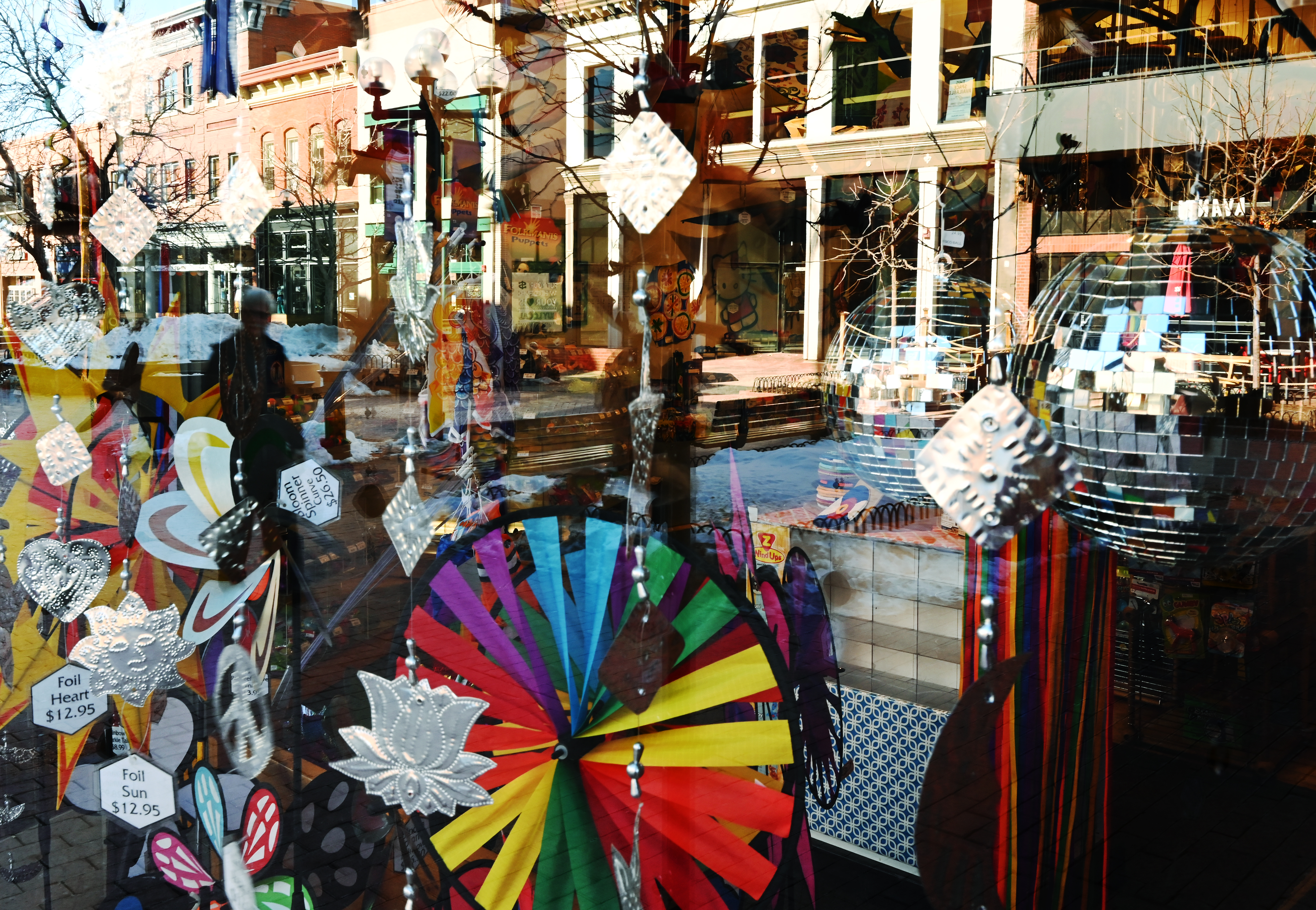 BOULDER, COLORADO - FEBRUARY 8: People are seen in the window reflection walking past a kite and toy store called Into The Wind, on the Pearl Street Mall, on February 8, 2022 in Boulder, Colorado. Weather in the Boulder area was sunny and mild. (Photo by RJ Sangosti/The Denver Post)