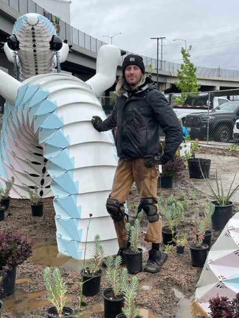 Kevin Williams, assistant curator at Denver Botanic Gardens, poses outside Meow Wolf Denver in June as he begins to plant his Alien Dream Worlds garden. (Provided by Meow Wolf Denver)