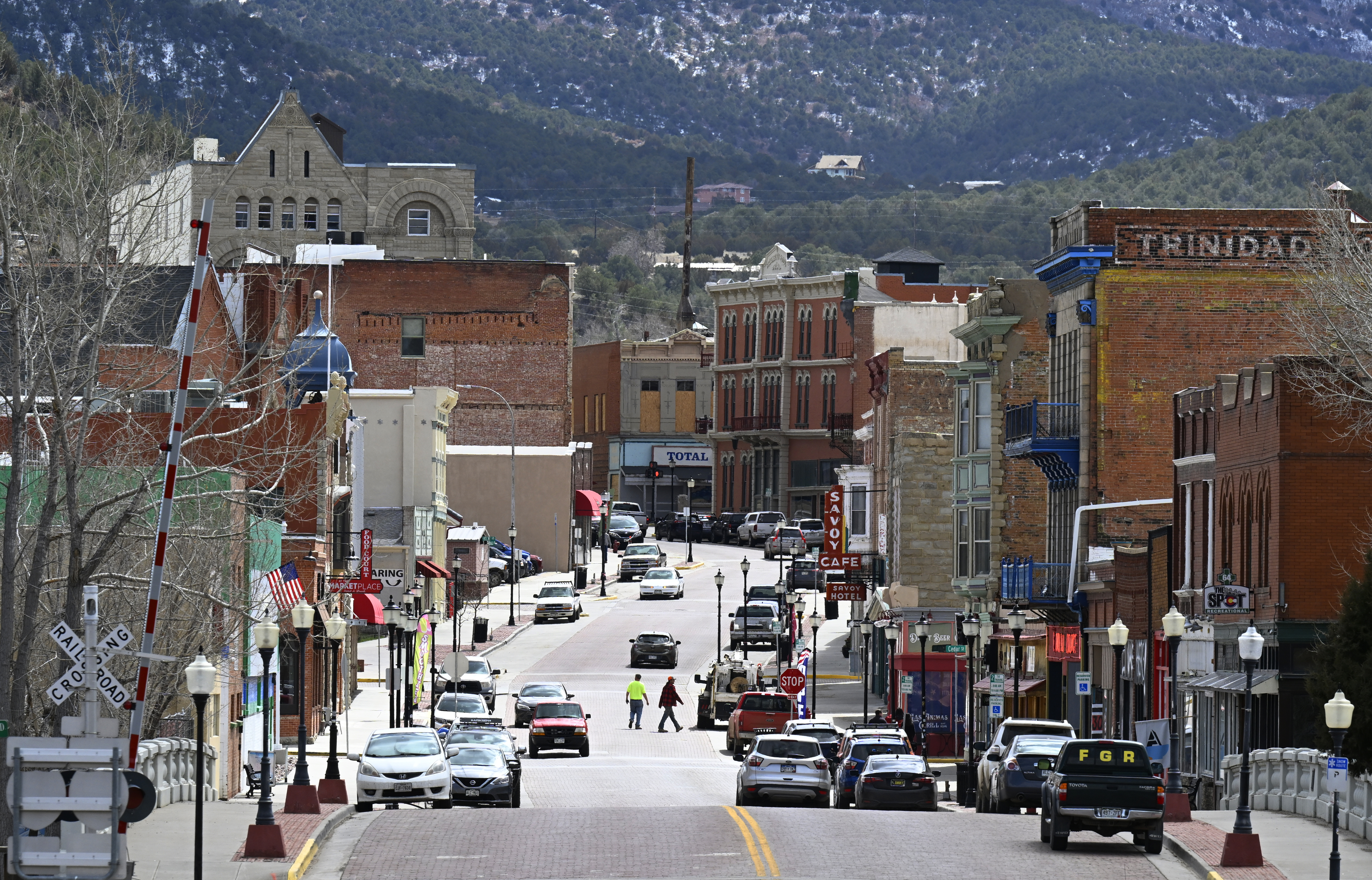 TRINIDAD, COLORADO - MARCH 20: Pedestrians cross the roadway on March 20, 2023 in Trinidad, Colorado. Trinidad near the Colorado and New Mexico state line has around 20 marijuana dispensaries. The state legislature will be considering this spring an implementation bill for Prop 122, which legalized mushroom use in Colorado. (Photo by RJ Sangosti/The Denver Post)