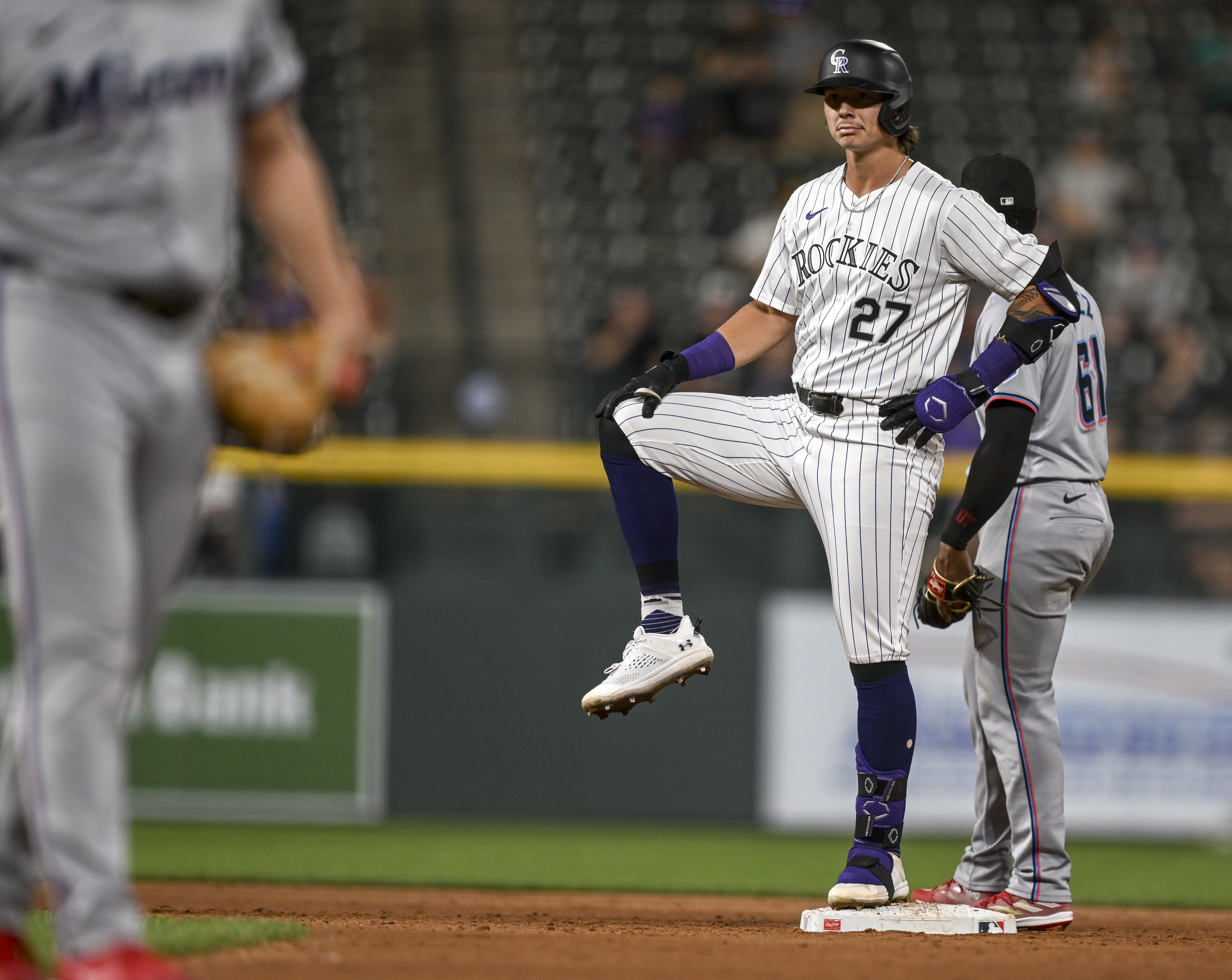 Jordan Beck (27) of the Colorado Rockies celebrates hitting a double off of Jonathan Bermúdez (73) of the Miami Marlins by lifting his leg during the sixth inning at Coors Field in Denver on Tuesday, Aug. 27, 2024. (Photo by AAron Ontiveroz/The Denver Post)