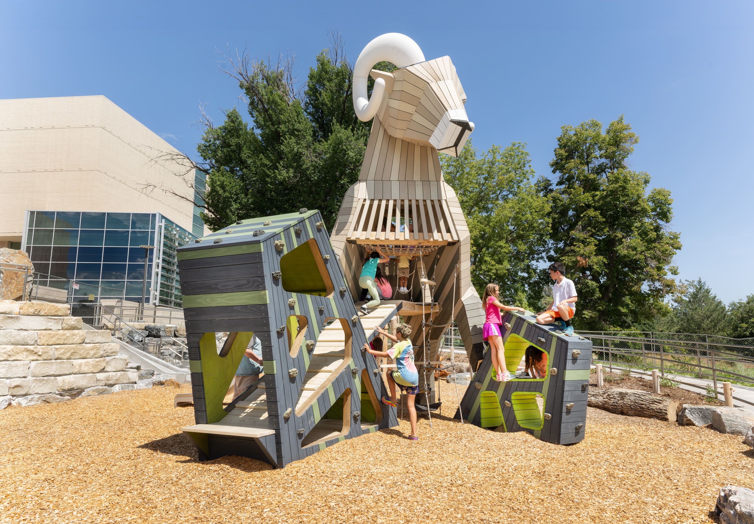 Children play on the 20-foot-tall Rocky Mountain Bighorn Sheep structure at Denver Museum of Nature & Science's Nature Play playground, a 4-acre interactive installation in City Park. (Photo by Rick Wicker, provided by DMNS)