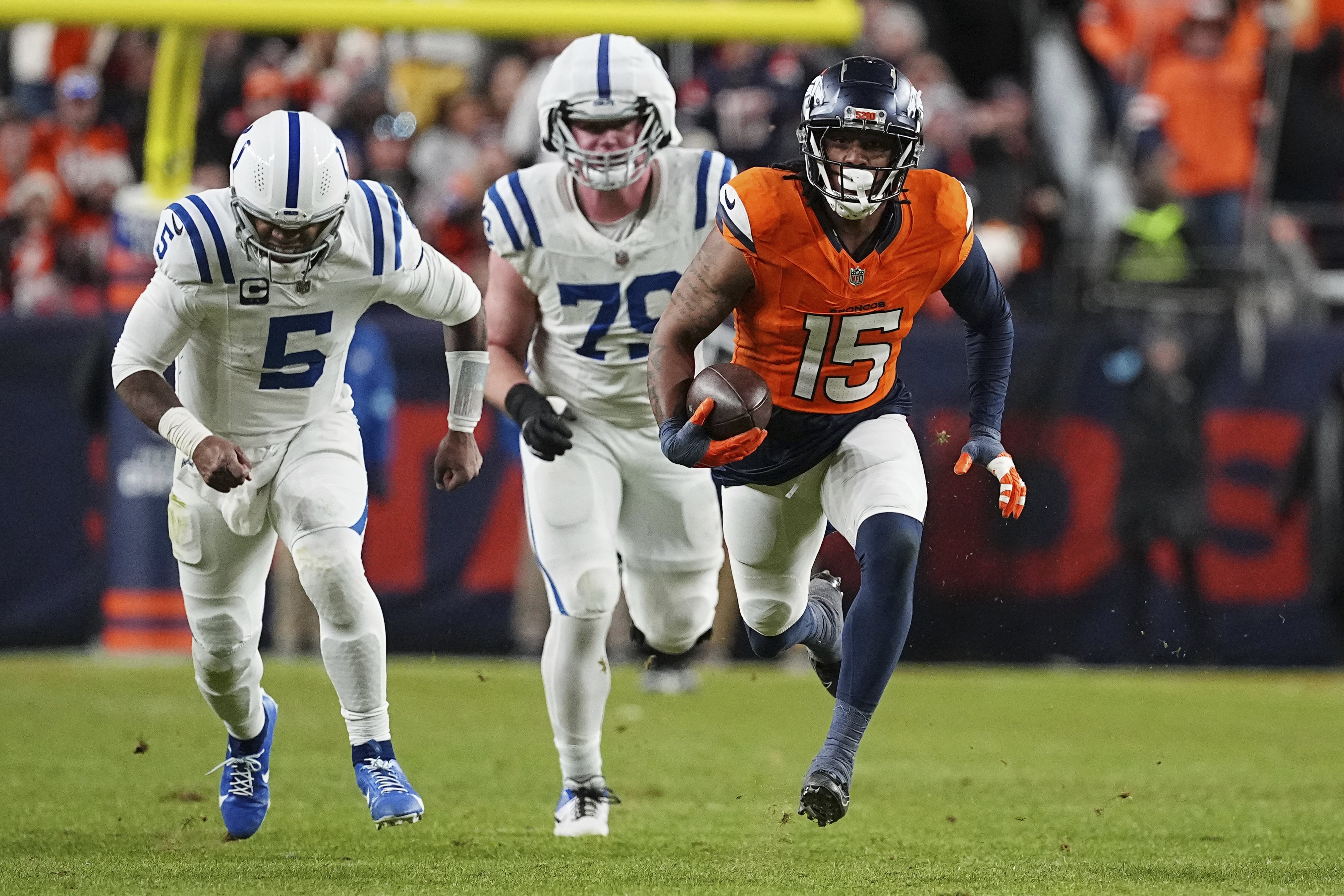Denver Broncos linebacker Nik Bonitto (15) intercepts the ball for a touchdown in the forth quarter against the Indianapolis Colts on Dec. 15, 2024, in Denver. (AP Photo/Bart Young)