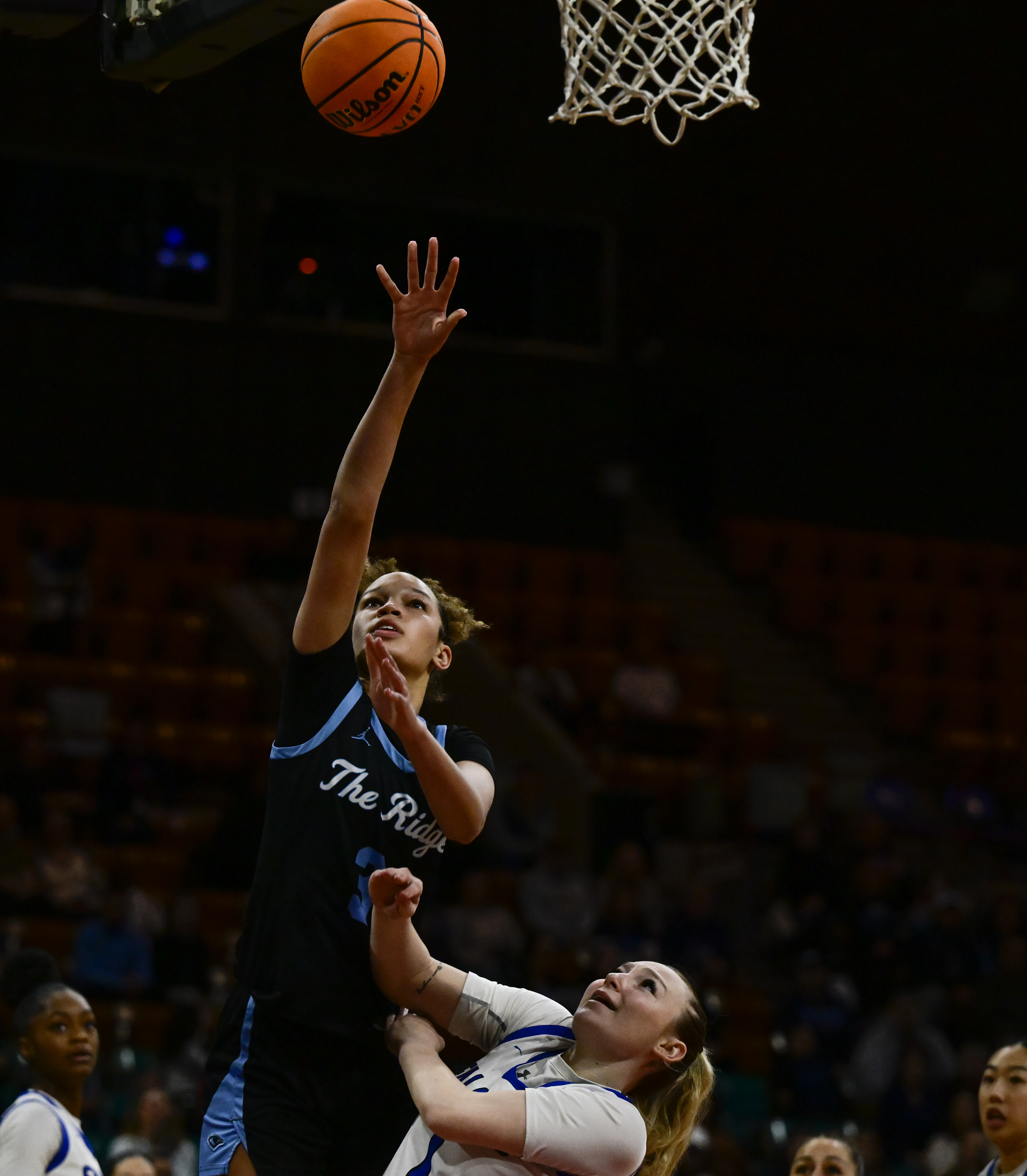 Brihanna Crittendon (3) of the Riverdale Ridge Ravens lays ups a basket against Tori Baker (1) of the Highlands Ranch Falcons in the first half of the state high school girls 6A Great Eight game at the Denver Coliseum in Denver on Saturday, March 8, 2025. (Photo by Andy Cross/The Denver Post)